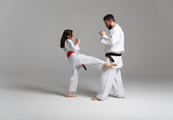 Father and daughter practicing kyokushinkai karate kicks together