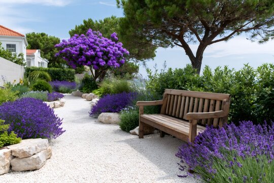 Fototapeta Gravel garden path with blooming lavender and wooden bench inviting to relax