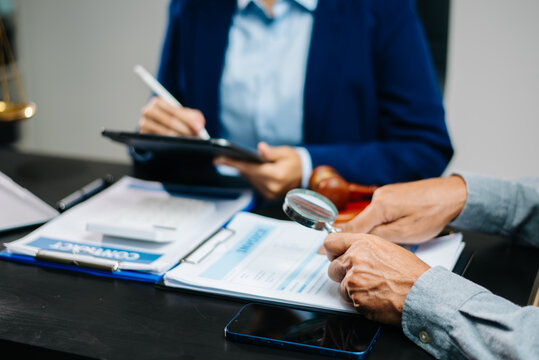 Lawyer reviewing invoice and contract with magnifying glass, tablet, and gavel. Legal consulting, document audit