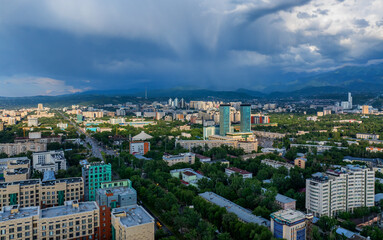 View from a quadcopter of the central part of the Kazakh city of Almaty and thunderclouds over the Zailiyskiy Alatau mountains
