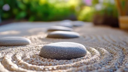  Gray stones arranged in a zen garden, sand patterns © 3Ummu