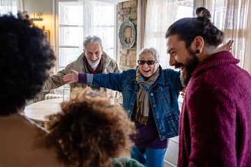 Happy multiethnic multi-generational family enjoying Christmas time together. People love concept.