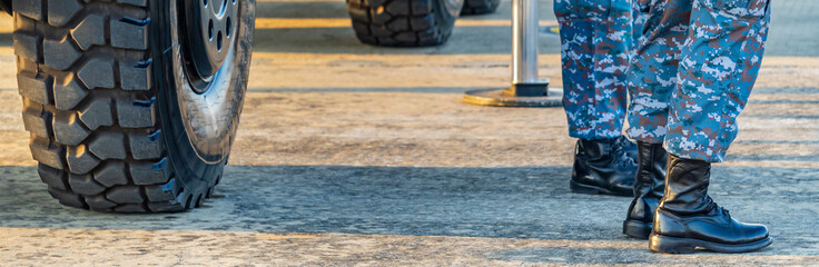 Soldiers in military uniforms wear military combat boots.