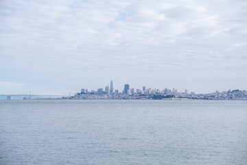 Naklejka premium Panoramic view of San Francisco skyline from across the water under a soft cloudy sky, Marin County, CA, January 30, 2021
