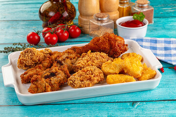 Golden crispy fried chicken mix - wings, drumsticks, nuggets and strips
