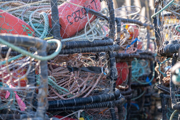 Close-up of tangled fishing lines and netting inside stacked crab pots at Bodega Bay, California,...