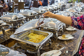 Many buffet dishes that are lined up serving the hotel's customers.