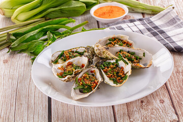 Gournet grilled oysters with onion and peanut