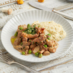 Vegan polenta with mushrooms and plant-based strips on white plate