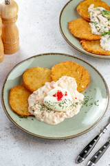 potato pancakes with sauce and herbs