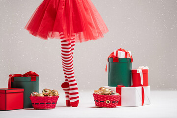 ballerina with red tutu and striped tights among Christmas gifts