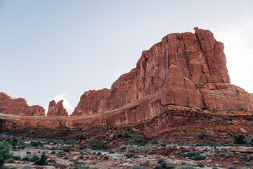 Layered red rock cliffs with visible strata in Arches, Utah