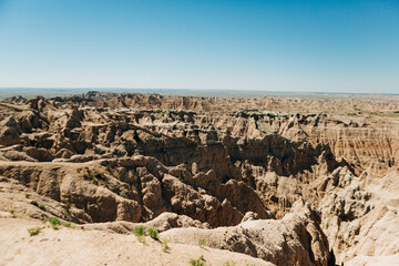 Expansive canyon view beneath clear skies in Badlands, South Dakota