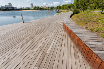Enjoy the breathtaking view of a Scenic Boardwalk adjacent to a Serene Waterbody, all embraced by...