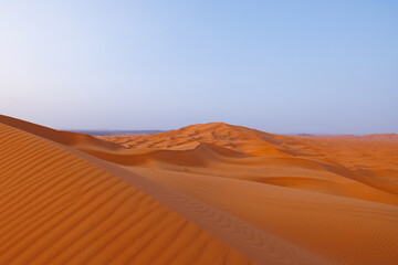 Sunrise panoramic landscape views of Erg Chebbi sand dunes located in Morocco on the western edge...