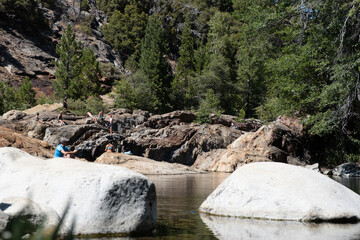 Granite boulders and forest reflections in calm Lake Tahoe creek, July 30, 2020