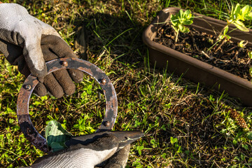 Woman cleans rust from rusty old garden lamp with sandpaper,