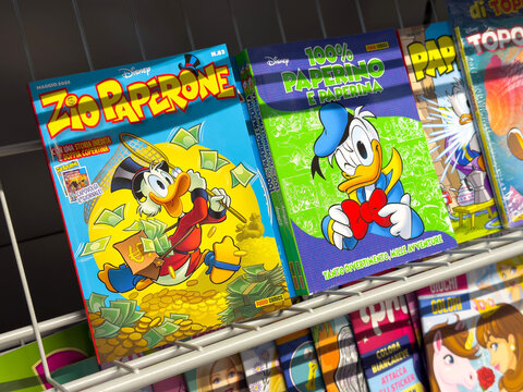 Tarvisio, Italy - June 01, 2025: Zio Paperone comic book covers featuring Scrooge McDuck surrounded by money, showcasing vibrant colors and playful illustrations for fans of Disney characters