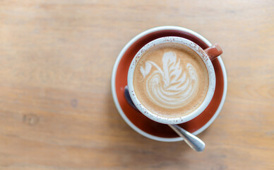 latte-art-coffee-cup-on-wooden-table.