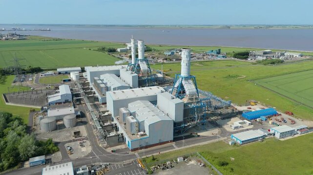 Aerial drone view of Power Station Humber South Bank near Immingham energy park electricity generation in England UK smoke stacks cooling towers with rural green fields nuclear gas coal oil fuel