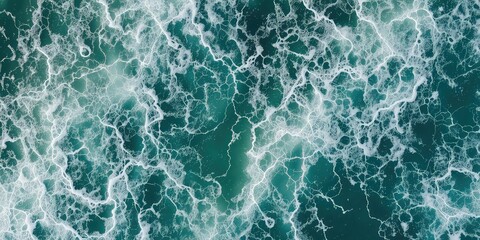 Aerial view of choppy ocean water creating a dynamic pattern of foam on the surface