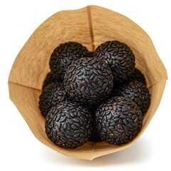 Obraz premium vegan black sesame balls in paper pouch, macro product texture , isolated on white background