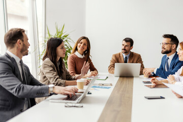 Group of businesspeople sitting in boardroom and working on a project together.