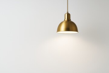 Obraz premium Elegant golden pendant light shining against a plain white wall background in a minimalistic and modern interior concept. Ai generative.
