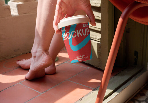 Holding a Cup in a Cozy Indoor Setting. PSD template mockup.