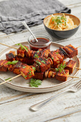 Tofu skewers with sauce and coleslaw
