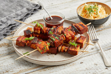 Tofu skewers with sauce and coleslaw