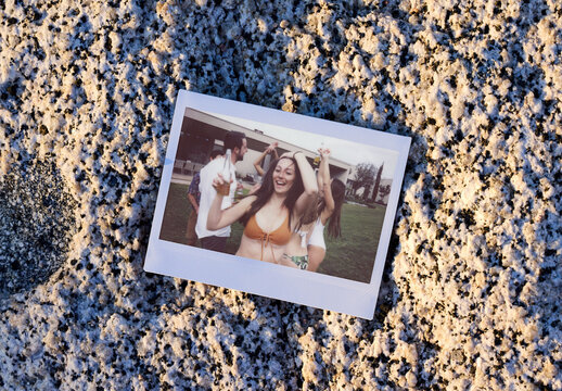Polaroid on Sandy Surface at Sunset Hour