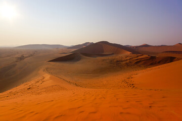 Naklejka premium View from red sand dune 45 on the surrounding dunes and plains, Sossusvlei , Namib-Naukluft, Namibia