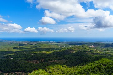 Discover the serene beauty of Mallorca, Spain, with a panoramic view of lush green hills leading to...