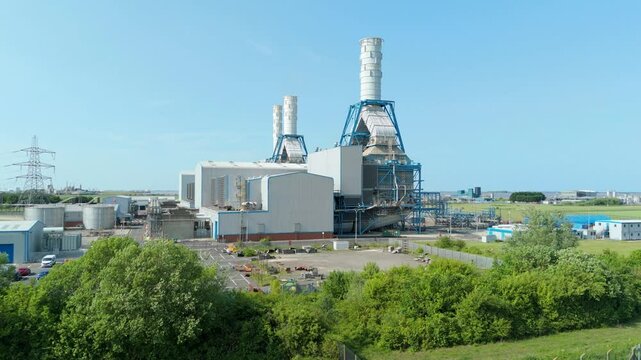 Aerial drone view of Power Station Humber South Bank near Immingham energy park electricity generation in England UK smoke stacks cooling towers with rural green fields nuclear gas coal oil fuel