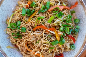 Savor the vibrant flavors of this Asian noodle dish, featuring colorful fresh vegetables, aromatic...