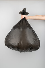 Hand Holding a Full Trash Bag – Waste Disposal Concept