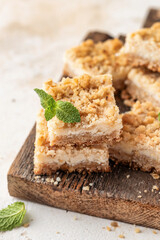 Lemon crumble bars on wooden cutting board close up. Oatmeal lemon bars