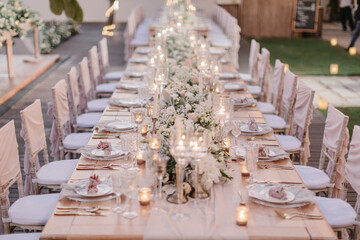 lovely Table setting for magnificent composition from flowers at a wedding , Centerpiece white and orange color palette flower bouquet arrangement