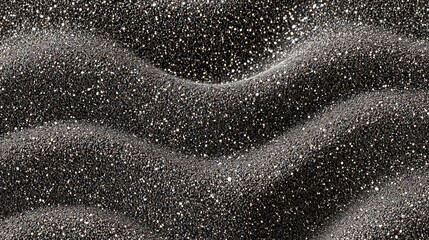 Textured black sand surface with shimmering particles creating a captivating natural pattern