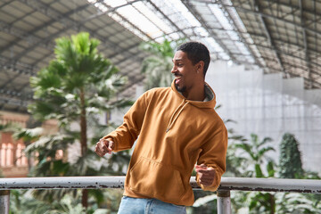 Young man dancing, wearing casual clothes, having fun