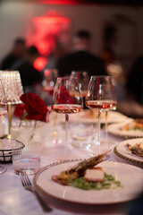 ​Elegant Wine Glasses with Wine on a Table
