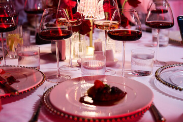 ​Elegant Wine Glasses with Wine on a Table