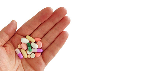 Hand holding a variety of pills and capsules