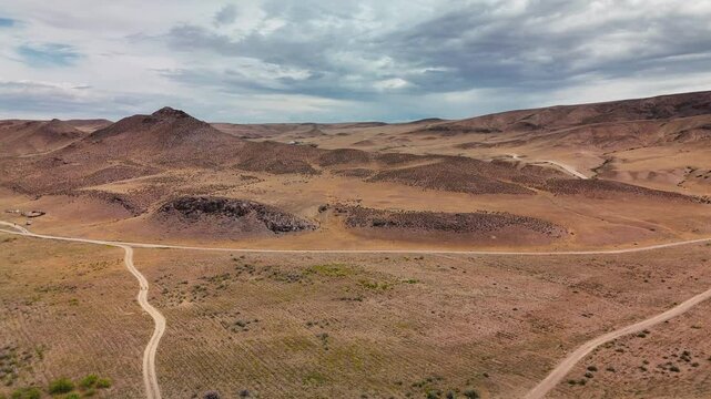 Drone shot of country road at spring steppe in Kazakhstan