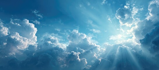 Sunbeams pierce through a dramatic, textured expanse of fluffy cumulus clouds against a vibrant blue sky