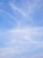 Fototapeta premium Clear blue sky with scattered white wispy clouds. freedom, and peaceful nature themes
