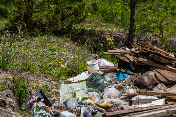 Illegal landfill pollutes natural landscape with discarded waste and debris in a forested area