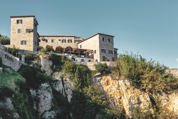 Fototapeta premium Old stone building on cliffside of Ulcinj Castle under clear sky, Montenegro