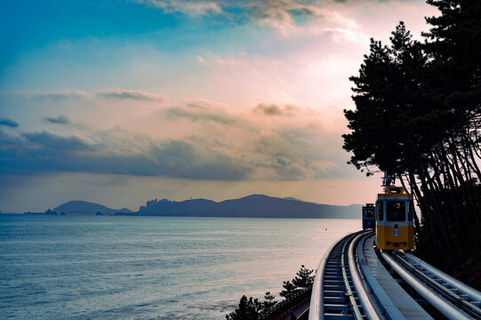 Riding the romantic cliff side train in the evening, Busan, South Korea